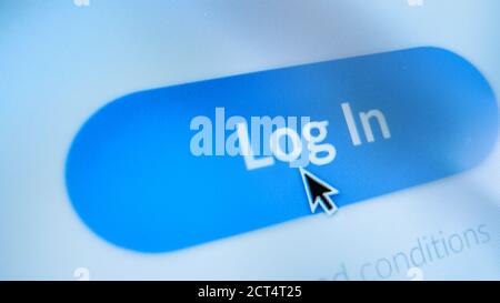 Close-up Macro Shot: Device Screen with Website Showing Blue 'Log In' Button, Cursor Clicks on the Button. Mock-up Concept of Website Social Media Stock Photo