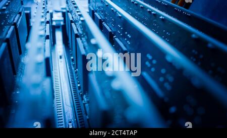 Close-up Macro Shot: Inside of the Computer Case. PCB Motherboard with Multiple Slots with RAM Memory Installed, and Other System Hardware. Stylish Stock Photo