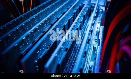 Close-up Macro Shot: Inside of the Computer Case. PCB Motherboard with Multiple Slots with RAM Memory Installed, and Other System Hardware. Stylish Stock Photo