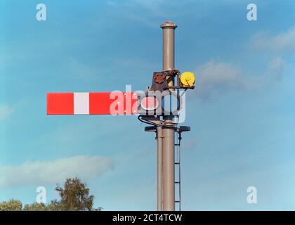 Old type semaphore signal at a railway station in England Stock Photo