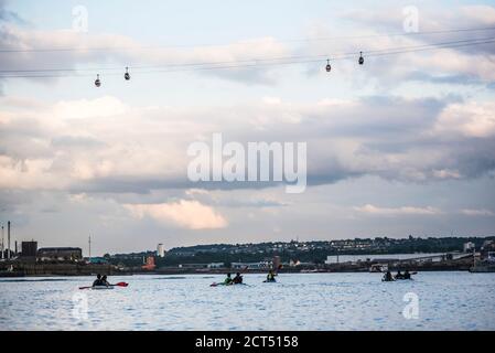 Kayaking under the Emirates Air Line Cable Car across the River Thames, Greenwich, London, England Stock Photo