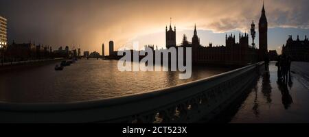 Houses of Parliament (Palace of Westminster) and Big Ben silhouetted at sunset, seen from Westminster Bridge, London, England Stock Photo