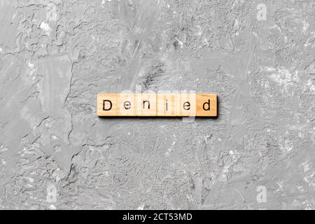 DENIED word written on wood block. DENIED text on cement table for your desing, concept. Stock Photo