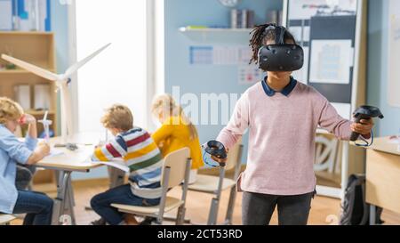 Elementary School Computer Science Class: Cute Girl Wearing Augmented Reality Headset and Using Controllers Learns Lessons in Virtual Reality Excited Stock Photo