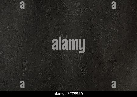 The dark texture of a  rough plastic surface with indented veins. Stock Photo