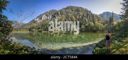 panoramic view- woman on mountain lake Duerrsee (Dürrsee) near Seewiesen in Styria, Austria Stock Photo