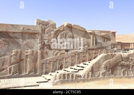 Famous bas-relief on the wall in ancient city Persepolis,  Iran. The lion attacks the bull and bites it (symbolizes fertility of earth and change of s Stock Photo