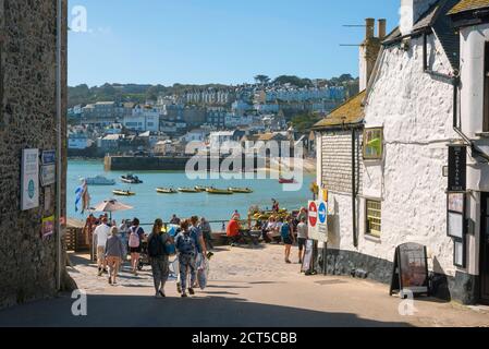 St Ives Cornwall, view in summer of people approaching the harbour area in St Ives, Cornwall, south west England, UK Stock Photo