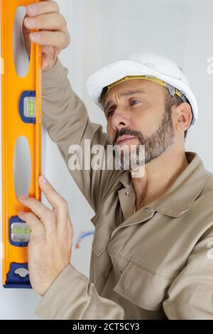worker using laser line level Stock Photo
