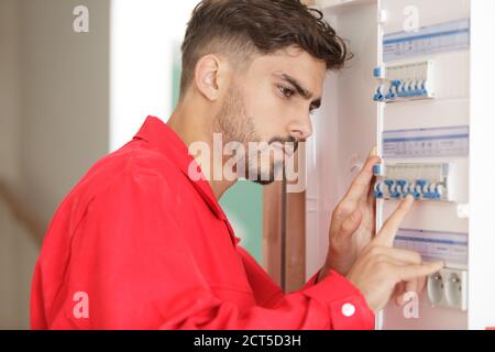 male electrician inspecting circuit breaker cabinet Stock Photo