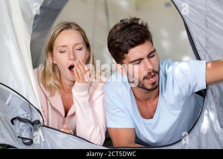 a happy couple waking up in a tent Stock Photo