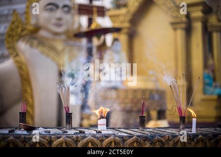 Burning prayer candles at Shwedagon Pagoda (aka Shwedagon Zedi Daw or Golden Pagoda), Yangon (Rangoon), Myanmar (Burma) Stock Photo