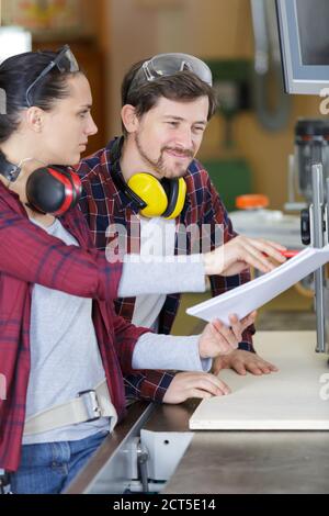 2 carpenters in wood workshop Stock Photo