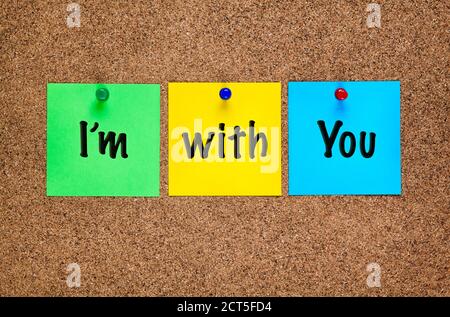 Three colored notes on corkboard with words I’m with You. Stock Photo