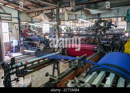 Machines in silk weaving workshop, textile factory in Amarapura, Burma Myanmar Stock Photo
