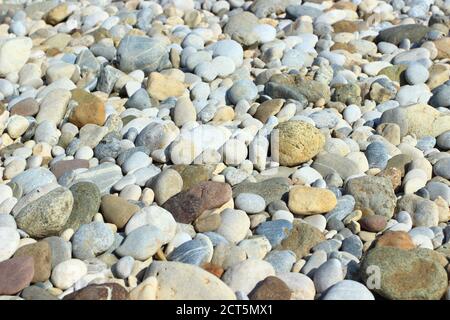 Colorful rounded rocks, pebbles on the river coast Stock Photo