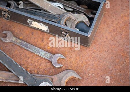 Old wrenches on a rusty sheet of metal, close-up, selective focus Stock Photo