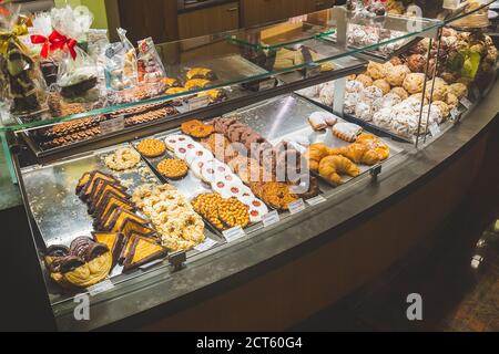 A showcase with a variety of pastry in a bakery in a German town. A Schneeball (eng. snowball) is a pastry made from shortcrust pastry and is especial Stock Photo