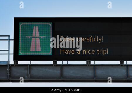 Led road sign billboard on a highway, green motorway road sign, drive carefully, have a nice trip Stock Photo