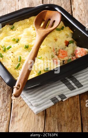 Homemade shepherd salmon pie close-up in a baking dish on the table. vertical Stock Photo