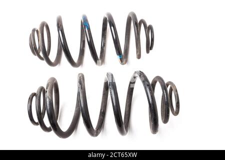 Automotive suspension springs for car chassis repair on a white background. Auto service industry. Spare parts catalog. Stock Photo