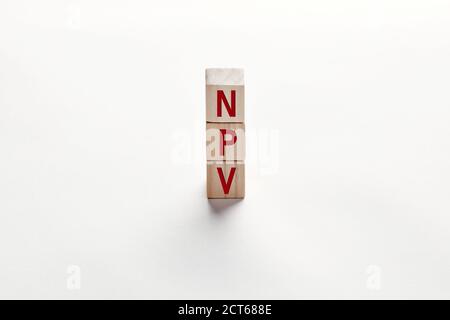 The word NPV net present value added tax on wooden cubes against white background. Financial management and investment growth in business concept. Stock Photo