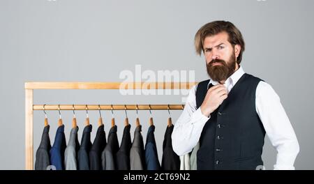 Man picking suit from personal wardrobe, fashion clothes concept. Stock Photo