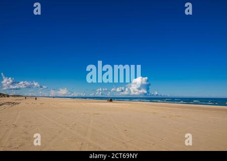 The large North Sea beach near Løkken in Denmark, Brown SUV driving along Stock Photo