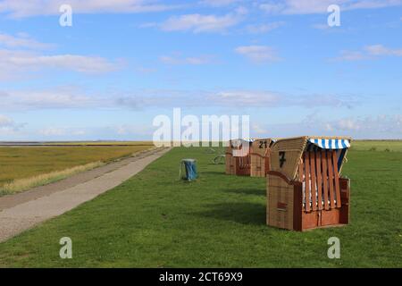Beach chairs on the grass, by the North Sea. In Spieka-Neufeld near Cuxhaven, Germany, Europe. Stock Photo
