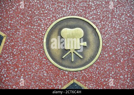 LOS ANGELES, CA, USA - MARCH 27, 2018 : The Hollywood Walk of Fame star in Los Angeles. Film camera gold emblem representing motion pictures. Stock Photo