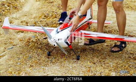 Red and white color RC plane on the ground for take off. Stock Photo