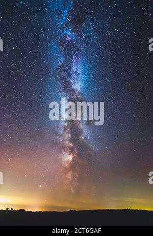 Landscape with Milky way galaxy glowing in the night sky Stock Photo
