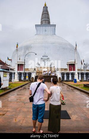 Sacred City of Anuradhapura, two tourists sightseeing at Ruvanvelisaya Dagoba in the Mahavihara (The Great Monastery), Sri Lanka, Asia Stock Photo