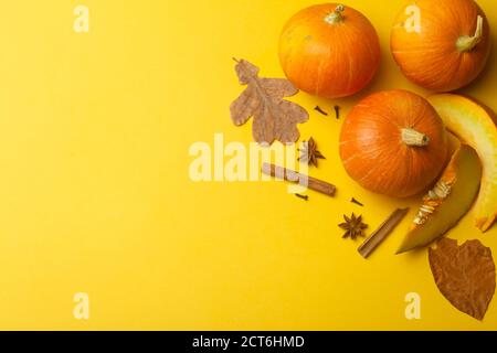 Autumn pumpkins on a yellow background. Concept for Autumn, Harvest, Halloween and Thanksgiving. Pumpkin Dishes Stock Photo