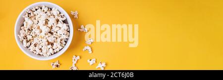Bowl of popcorn on yellow background Stock Photo