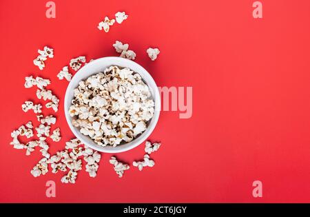 Bowl of popcorn on red background Stock Photo