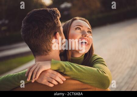 Back rear spine view portrait of passionate bonding girl hug boyfriend in autumn october park wear turtleneck jumper Stock Photo