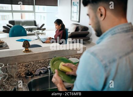 Business Woman Working At Home And Man Doing Chores Stock Photo