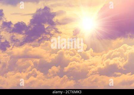 Sun with bright warm rays through dense clouds divine radiance of the sky Stock Photo