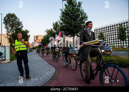 Amsterdam, Netherlands. 21st Sep, 2020. Activists riding bikes during the demonstration.For the second time and as a part of the new climate campaign, thousands of Extinction Rebellion activists blocked the main road of the financial district during an act of peaceful civil disobedience. With these actions, XR demand a Citizen's Assembly for fair climate policy. After a few hours, several of them were arrested by the Dutch police. Credit: SOPA Images Limited/Alamy Live News Stock Photo