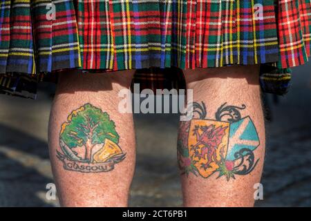 Man wearing a tartan kilt with tattoos on his legs showing Glasgow and support for Scottish independence, Taken at an independence rally, Glasgow, Stock Photo