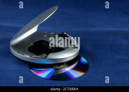 CD and portable CD player isolated against a blue background Stock Photo