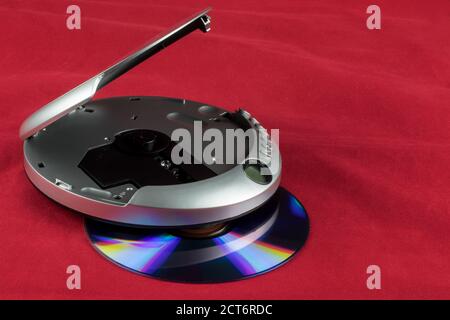 CD and portable CD player isolated against a red background Stock Photo