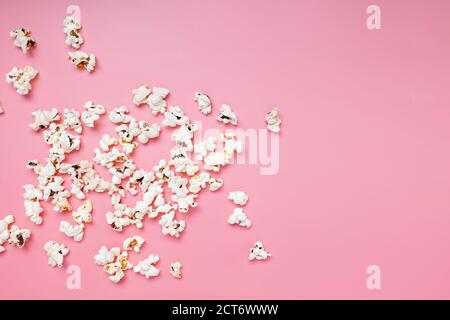 Popcorn scattered on pink background Stock Photo