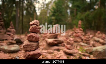 Harmonic pile of stacked sandstone rocks with beautiful soft brown color near a hiking trail in low mountain range Palatinate Forest. Stock Photo