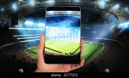 Watch a live sports event on your mobile Stock Photo