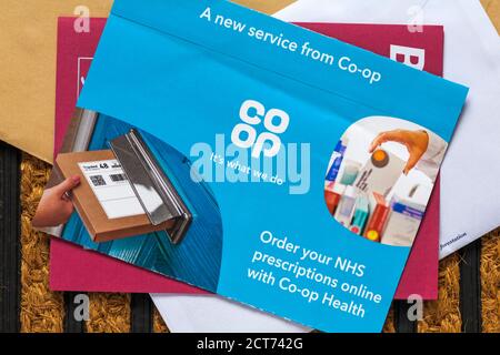 unsolicited mail junk mail on doormat - Coop order your NHS prescriptions online with Co-Op Health a new service from Co-Op Stock Photo