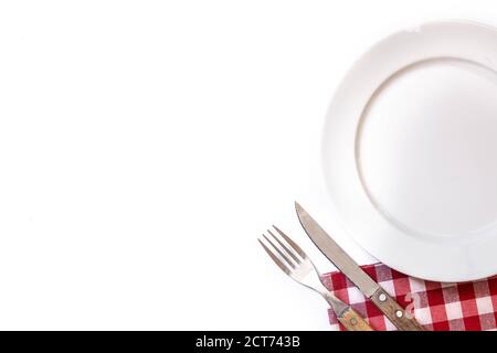 Empty white plate, fork and knife isolated on white background. Dinner concept Stock Photo