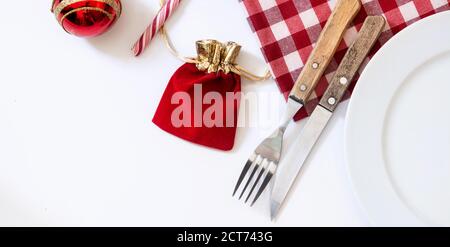 Empty white plate and Christmas ornament isolated on white background Christmas dinner concept. Stock Photo