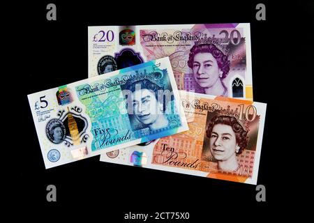 Britain new £5, £10 & £20 polymer banknotes on a black background Stock Photo